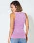 Woman wearing a purple ribbed tank top against a white background