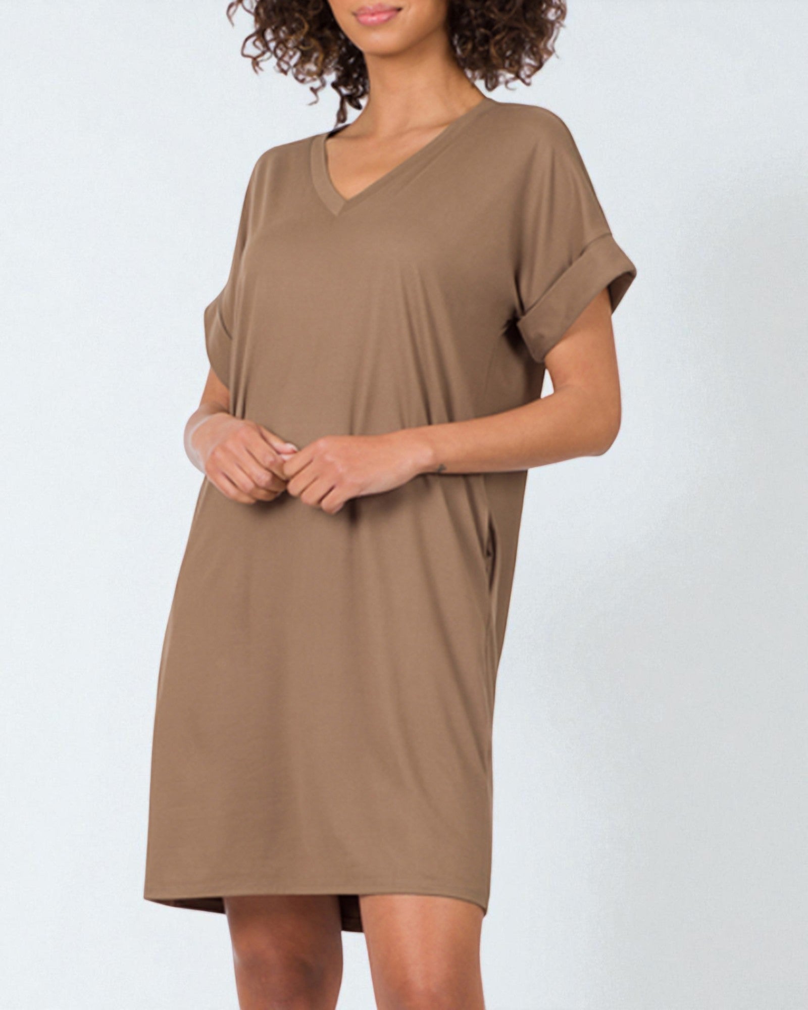 Woman wearing a brown dress against a white background