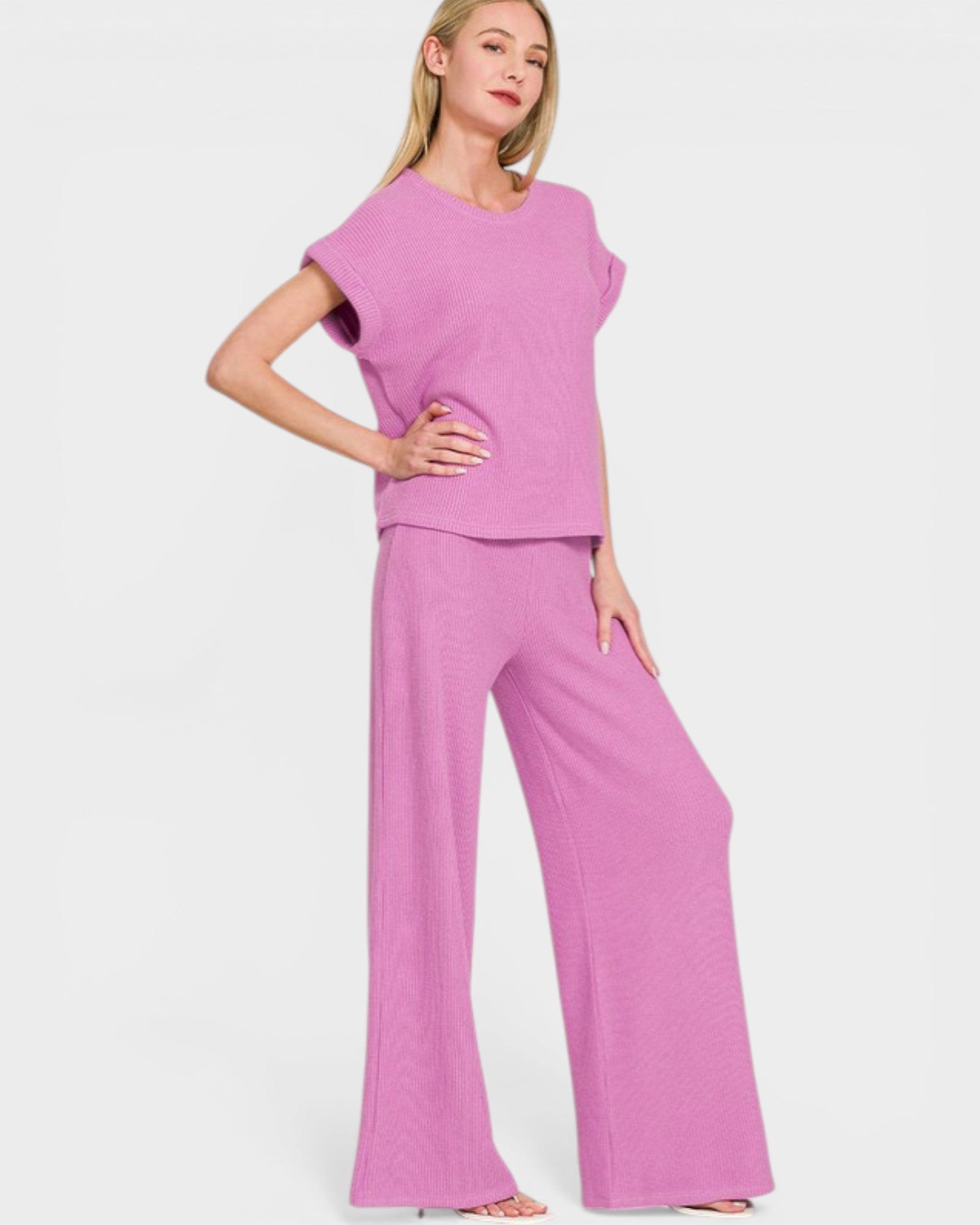 Woman wearing a pink outfit on a white background