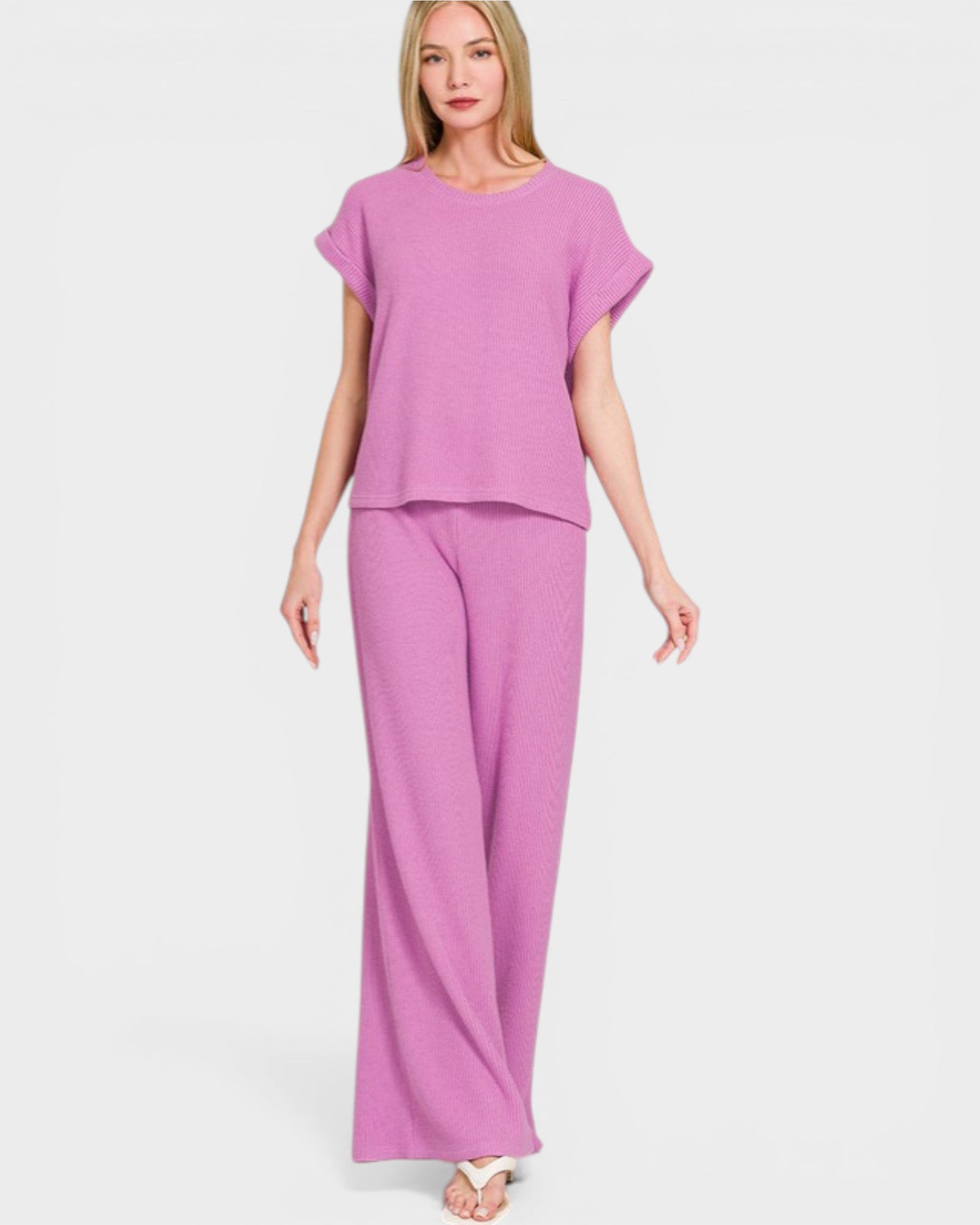Woman wearing a pink outfit on a white background