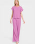 Woman wearing a pink outfit on a white background