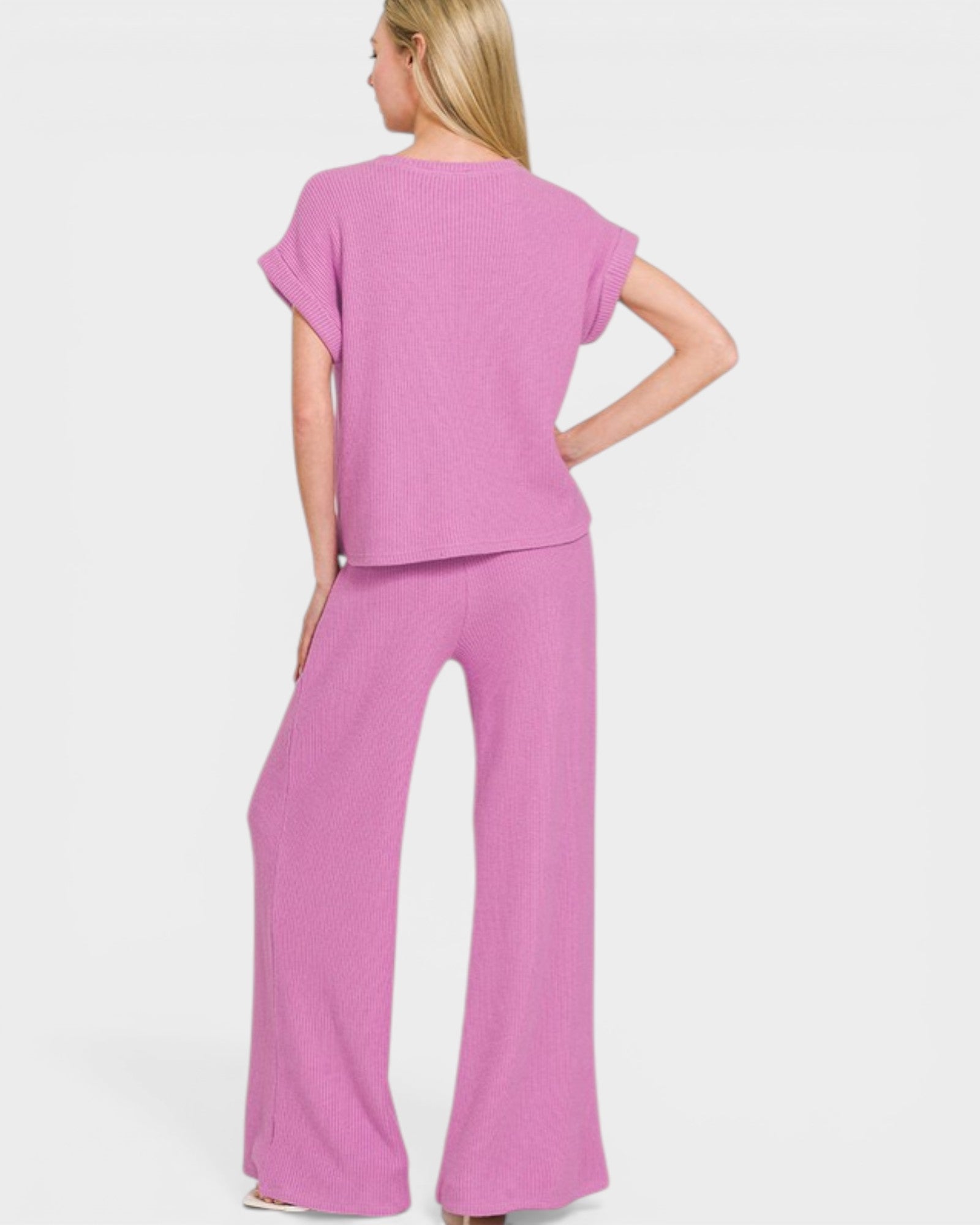 Woman wearing a pink outfit on a white background