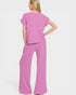 Woman wearing a pink outfit on a white background