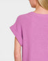 Person wearing a pink textured dress on a plain background