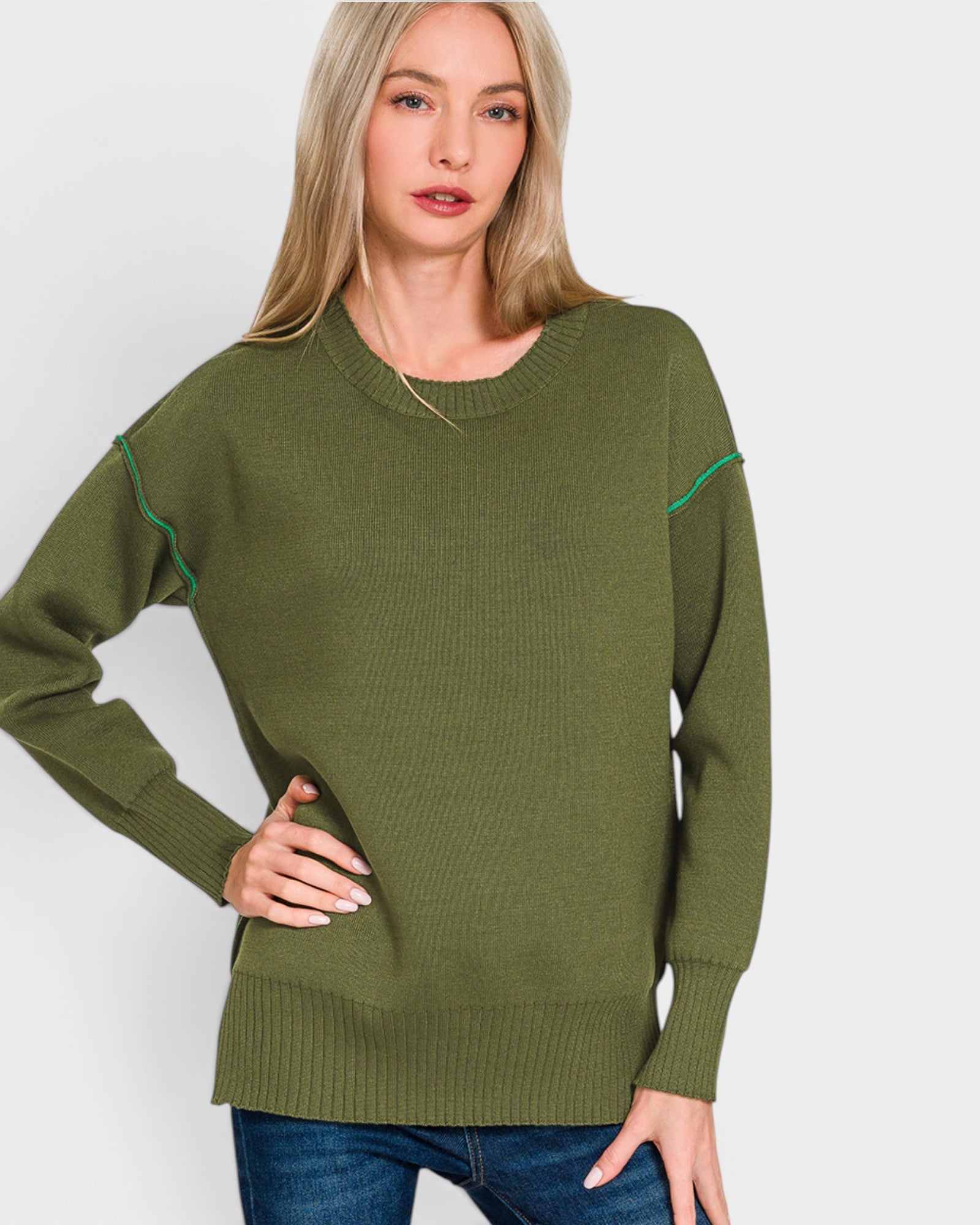 Woman wearing a green sweater with white background