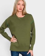 Woman wearing a green sweater with white background
