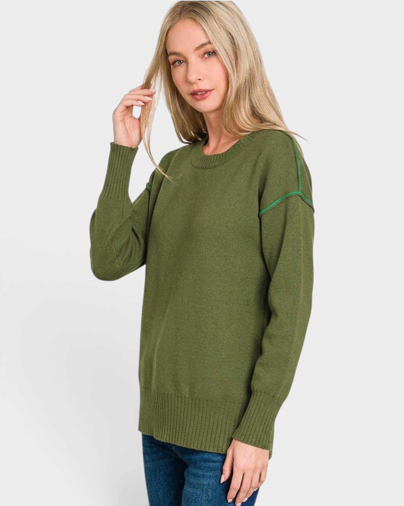 Woman wearing a green sweater on a white background