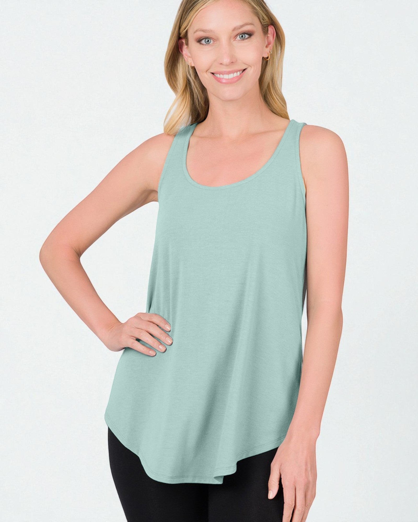 Woman wearing a light green tank top on a white background