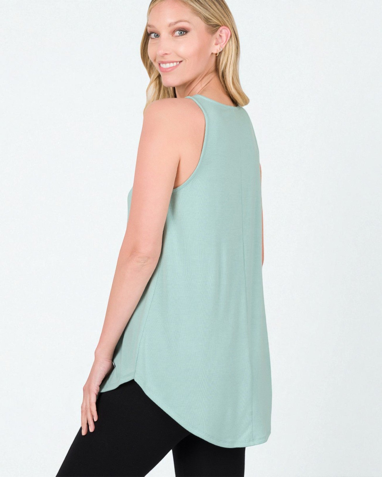Woman wearing a light green sleeveless top on a white background