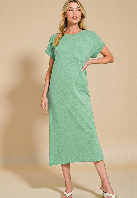 Woman wearing a green dress against a beige background