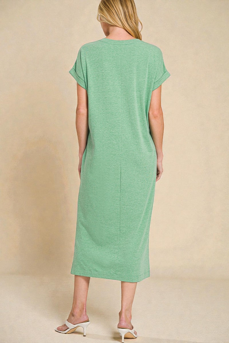 Woman wearing a green dress against a beige background