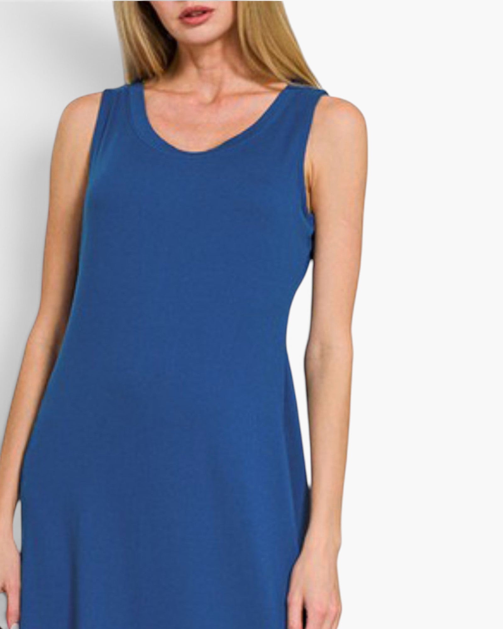 A woman wearing a sleeveless scoop-neck dress in a solid medium blue color, shown from the neck down against a light gray studio background.