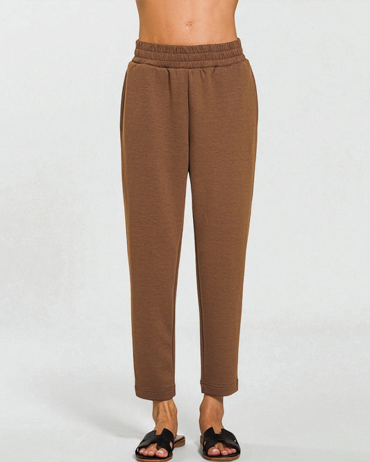 Brown pants worn by a person on a white background