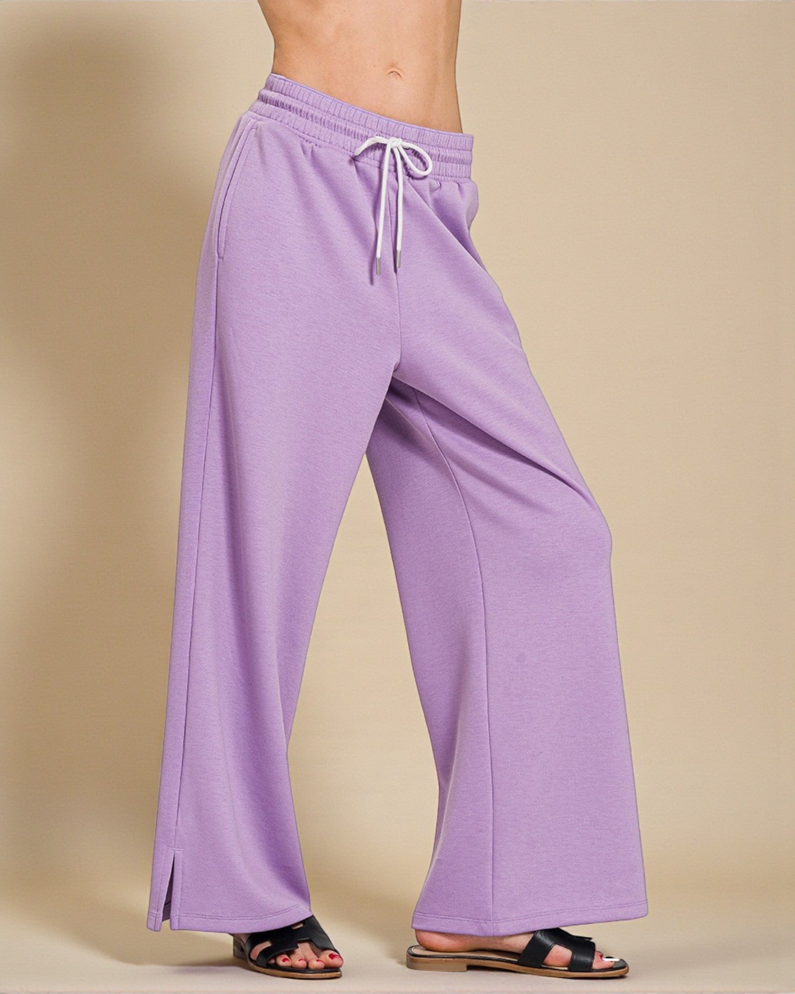 Purple wide-leg pants with a drawstring on a beige background
