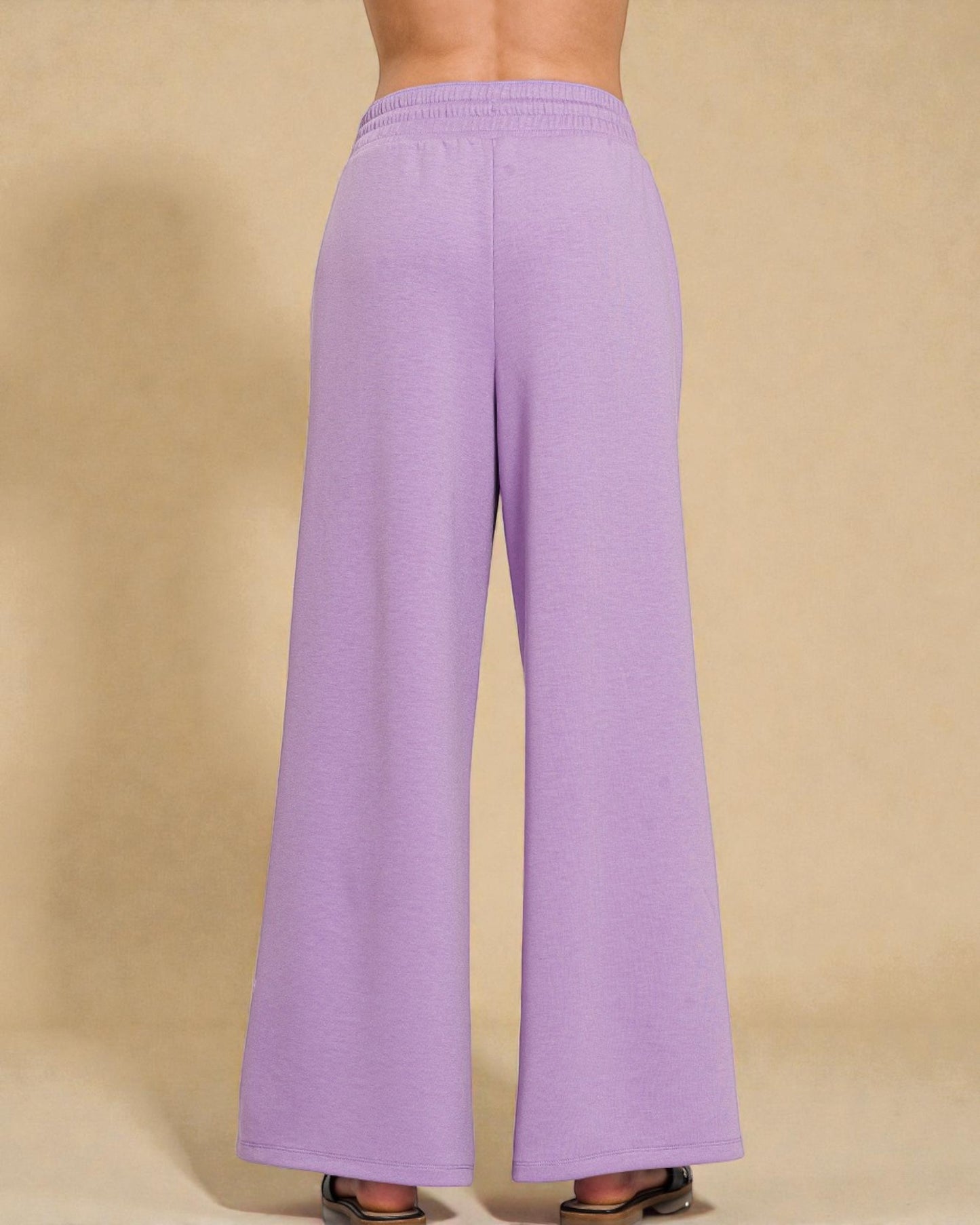 Purple wide-leg pants on a beige background