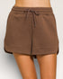 Brown shorts with a drawstring on a plain background