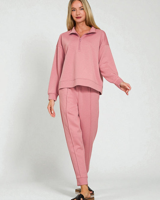 Woman wearing a pink tracksuit on a white background