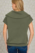 Person wearing an olive green top with a textured gray background