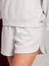 Gray sweatshirt and shorts set on a neutral background