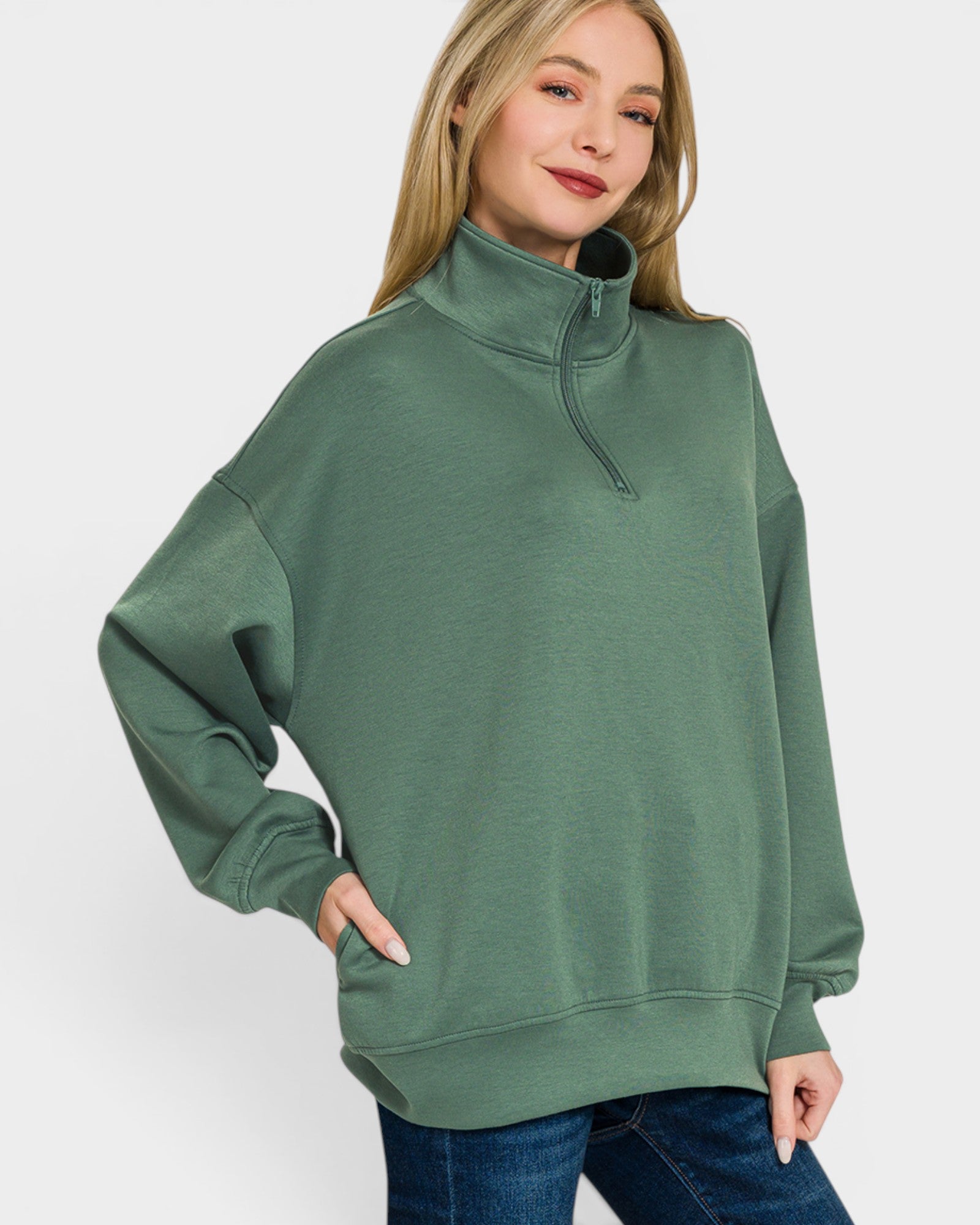 Woman wearing a green sweatshirt with a white background