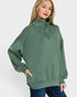 Woman wearing a green sweatshirt with a white background