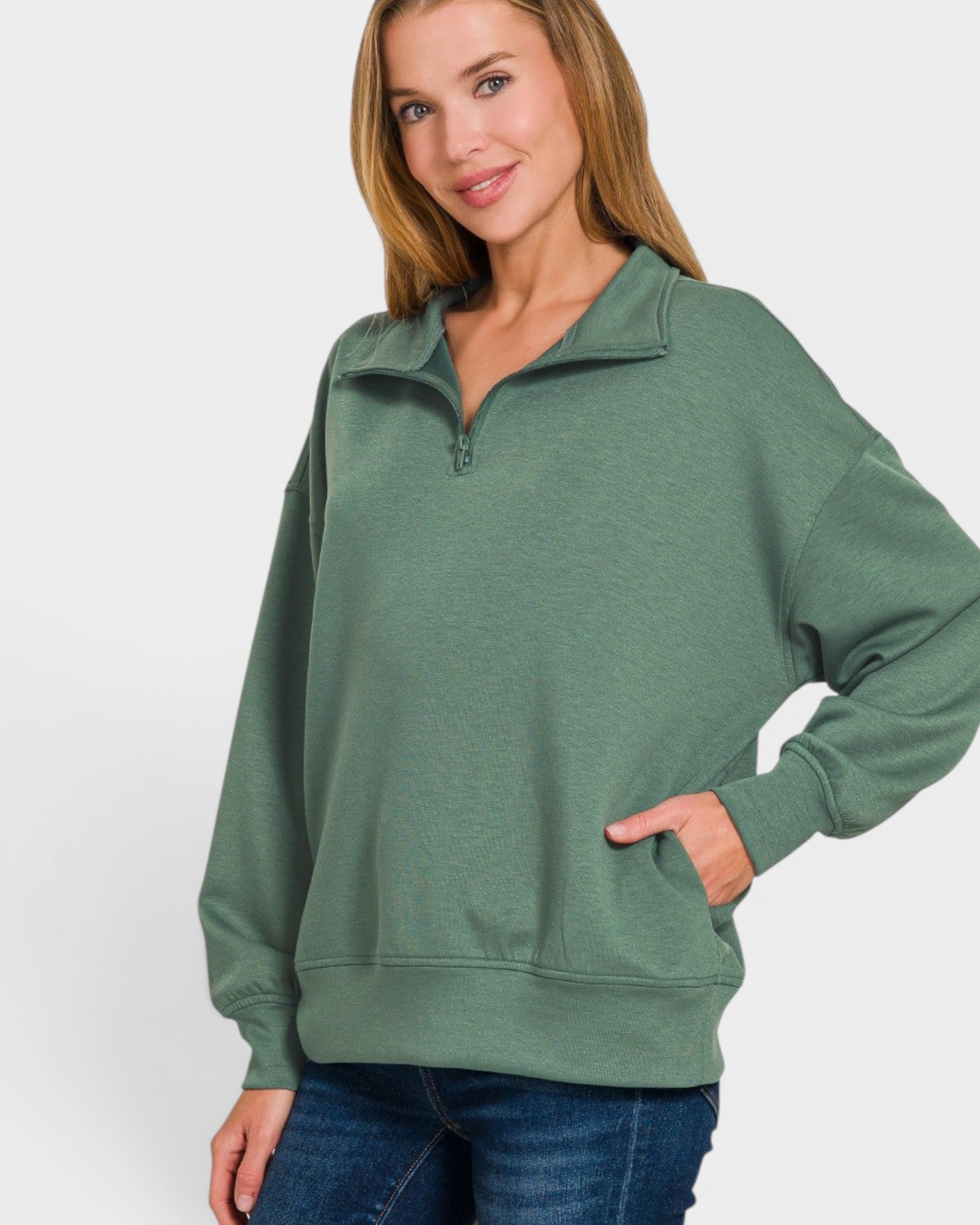 Woman wearing a green pullover with a white background