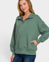Woman wearing a green pullover with a white background