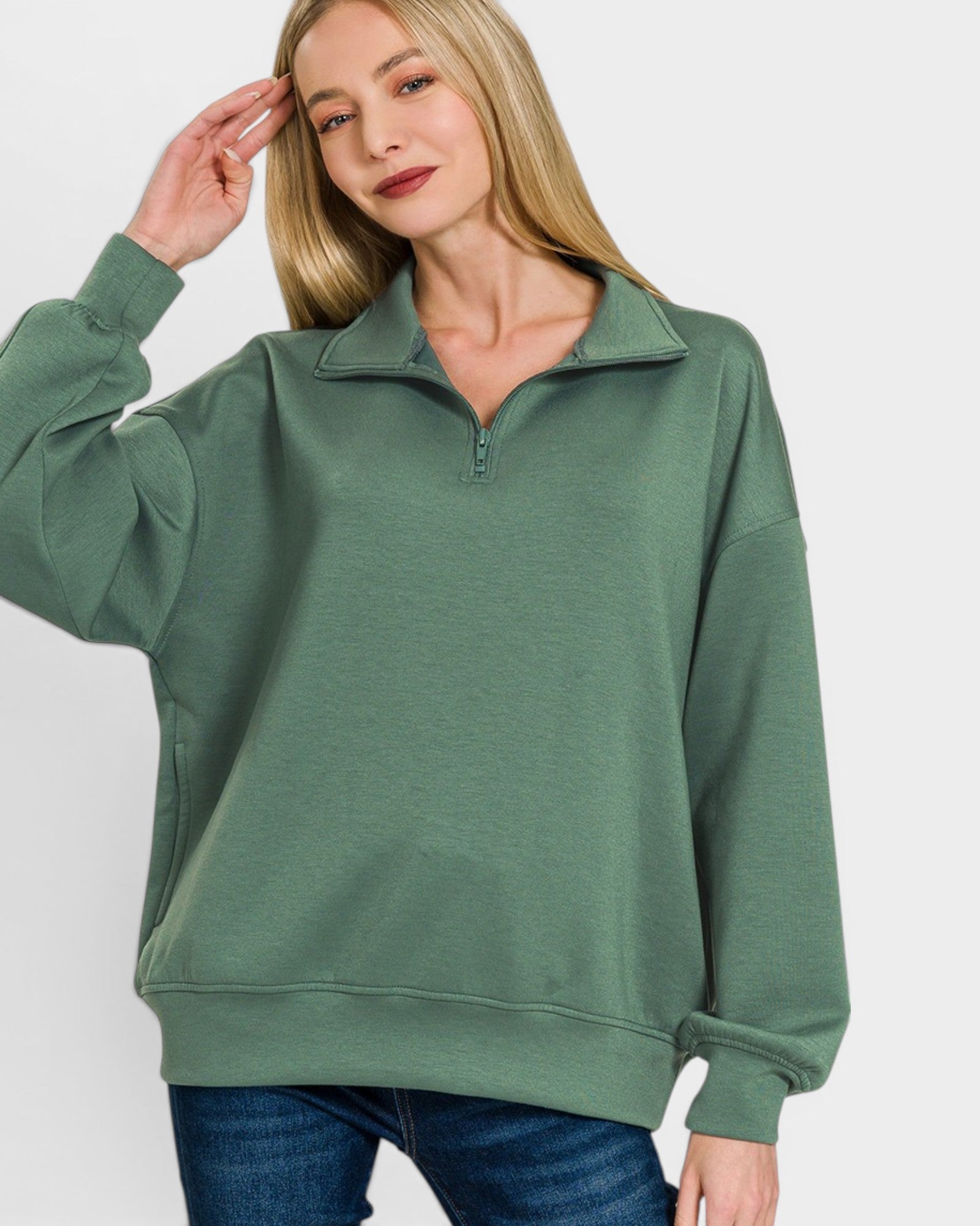 Woman wearing a green pullover with a white background