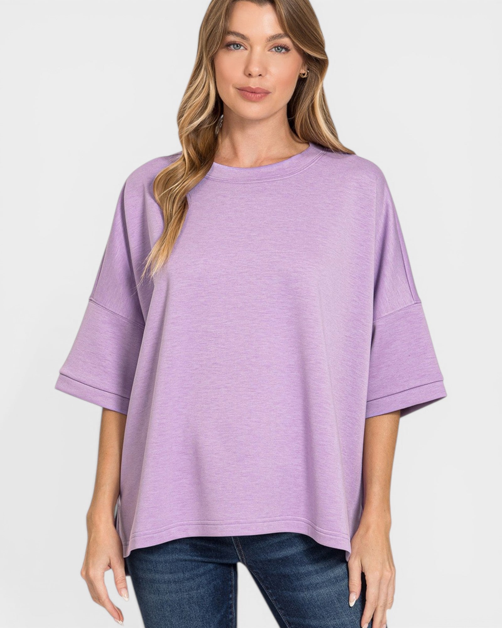 Woman wearing a purple oversized sweater on a white background