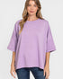 Woman wearing a purple oversized sweater on a white background