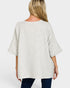 Woman wearing a light gray oversized shirt on a white background