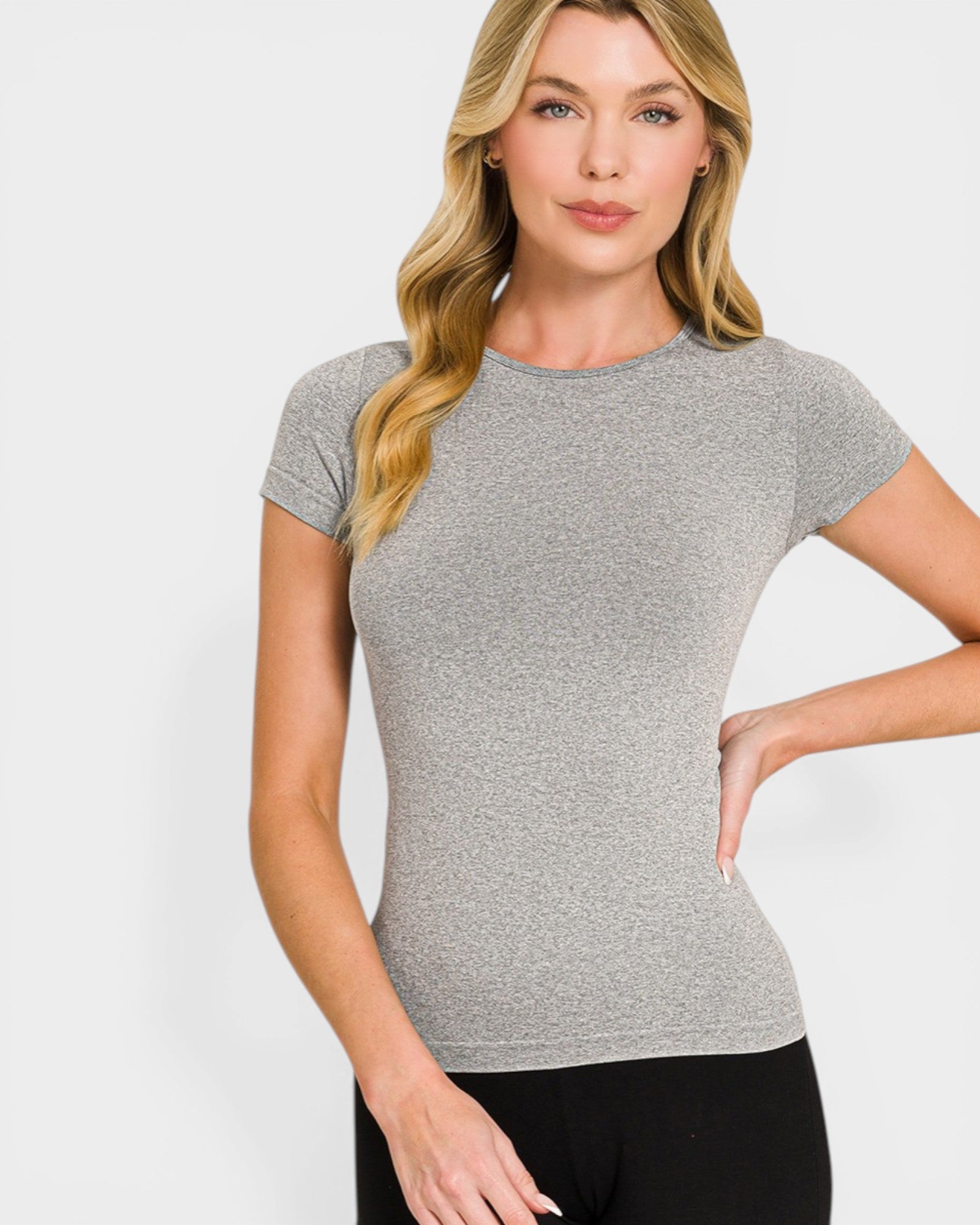 Woman wearing a gray short-sleeve top against a white background