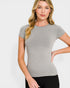 Woman wearing a gray short-sleeve top against a white background