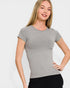 Woman wearing a gray t-shirt against a white background
