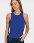 Woman wearing a blue ribbed tank top against a white background