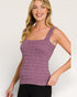 Woman wearing a purple knitted tank top on a white background