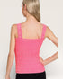 Woman wearing a pink crochet tank top against a plain background