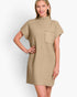 A woman modeling a short-sleeve ribbed knit mock-neck dress in a light tan/beige color, featuring a chest pocket, against a plain white studio background.