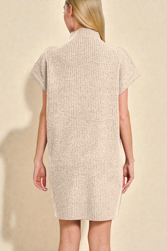 Woman wearing a beige textured dress against a beige background