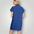 Woman wearing a blue dress against a plain background