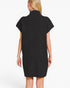 A woman shown from the back wearing a black ribbed knit mock-neck dress with short cap sleeves, photographed against a plain white studio background.