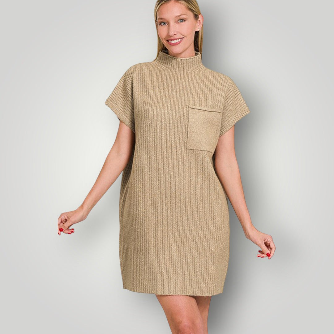Woman wearing a beige ribbed dress with a pocket on a plain background