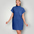 Woman wearing a blue dress with a pocket on a plain background