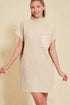 Woman wearing a beige ribbed dress with a pocket on a beige background