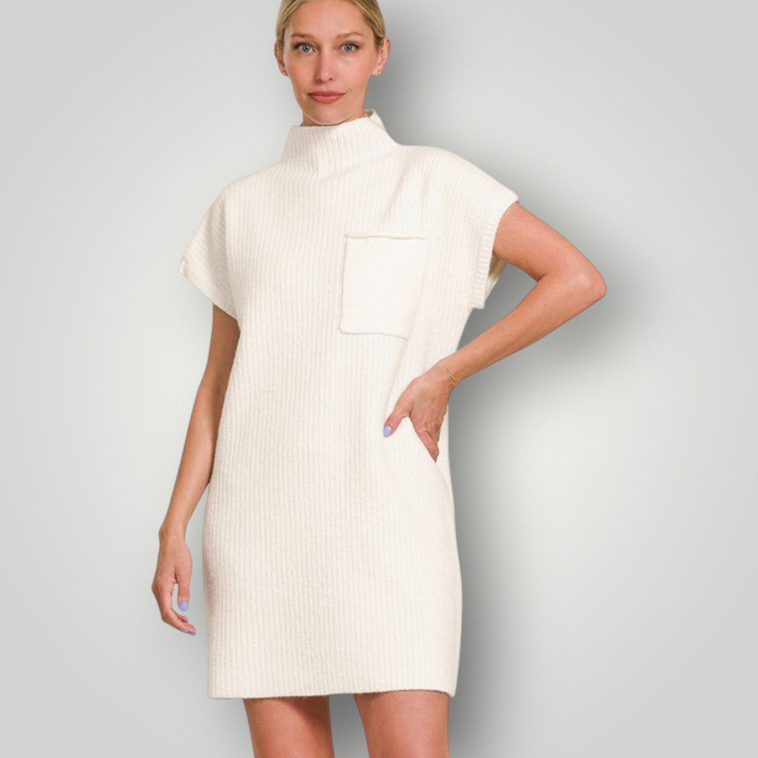 Woman wearing a cream-colored dress against a plain background