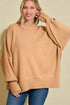 Woman wearing a tan sweater with a beige background