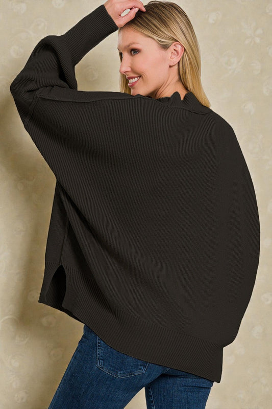 Woman wearing a black sweater over a blue shirt against a beige background