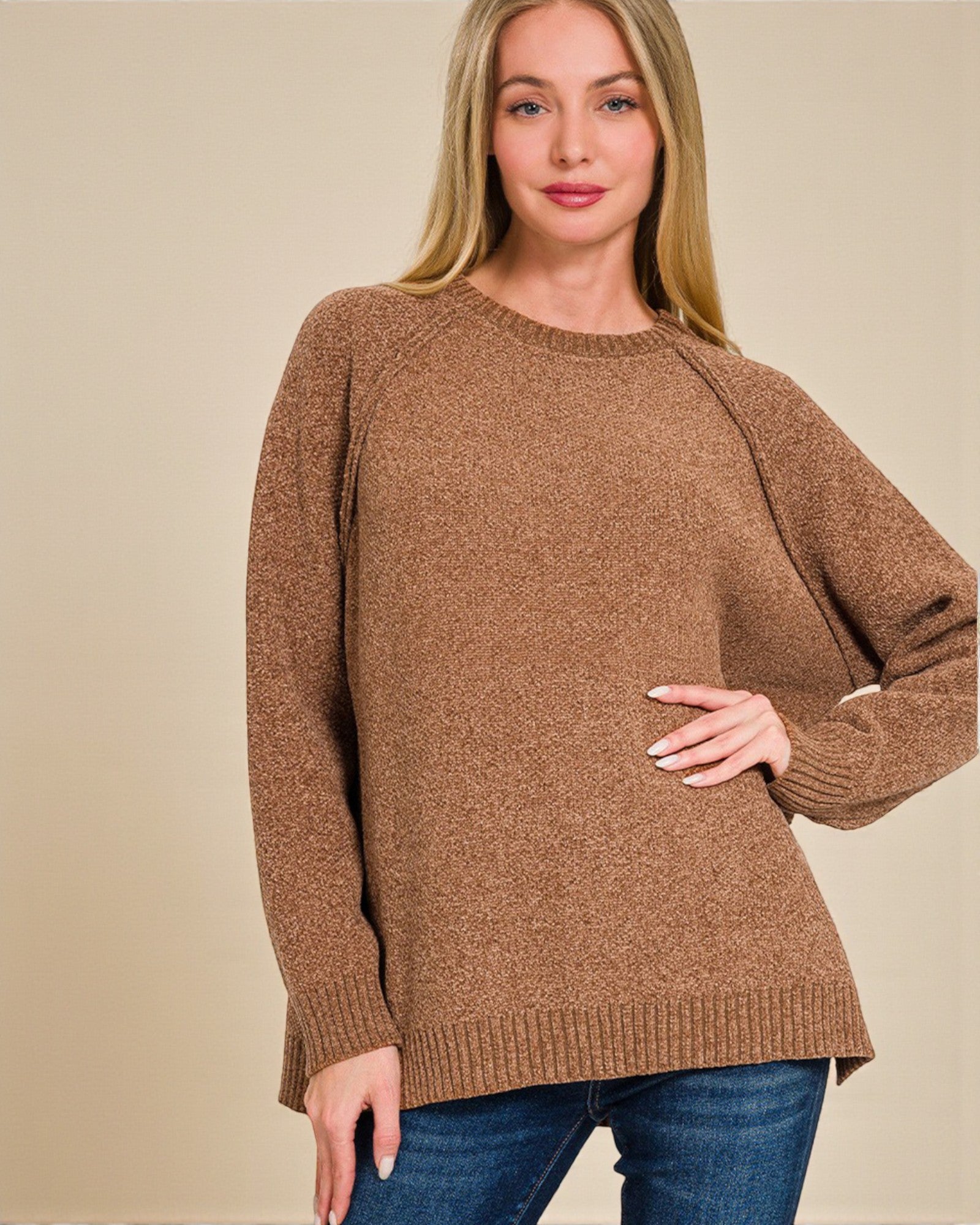 Woman wearing a brown sweater against a beige background