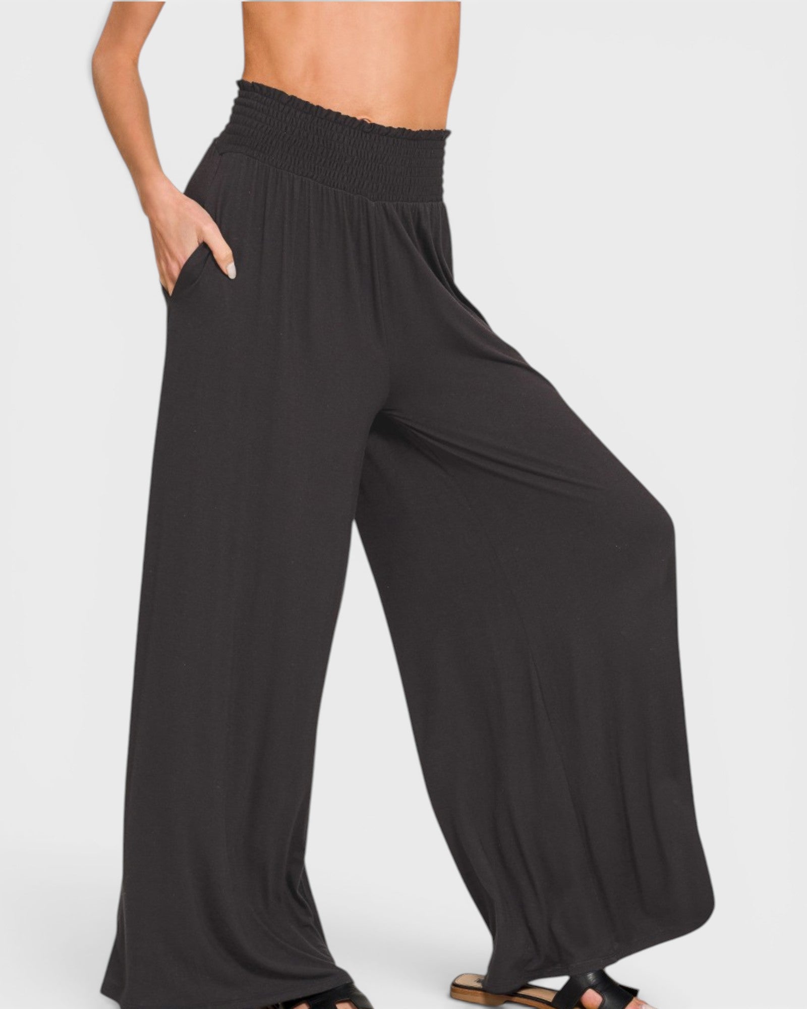 Black wide-leg pants worn by a person on a white background