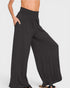 Black wide-leg pants worn by a person on a white background